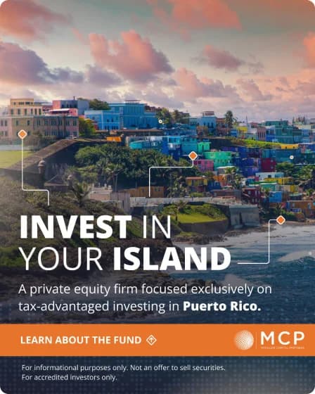 MCP ad, “Invest in your island”, over a hillside town in Puerto Rico